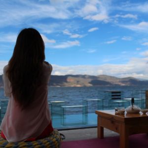 woman watching the see from her balcony